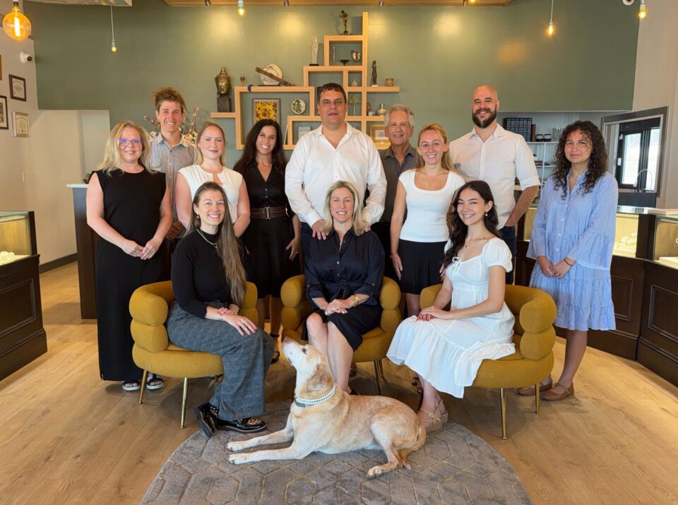 Eco Estate Jewelry team and shop dog gathered in the showroom gallery