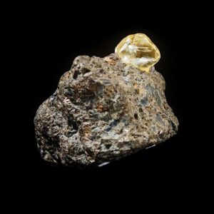 An image of a natural raw diamond in host rock. 