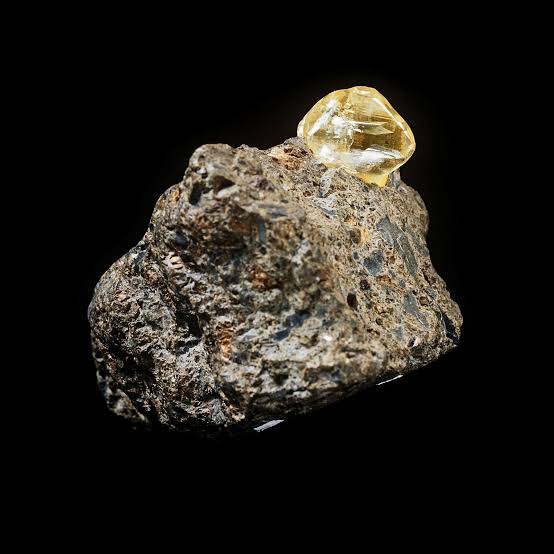 An image of a natural raw diamond in host rock.