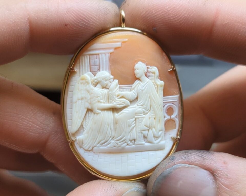 Antique carved shell cameo pendant held at the bench, reset in a new 14k gold bezel by Eco Estate Jewelry